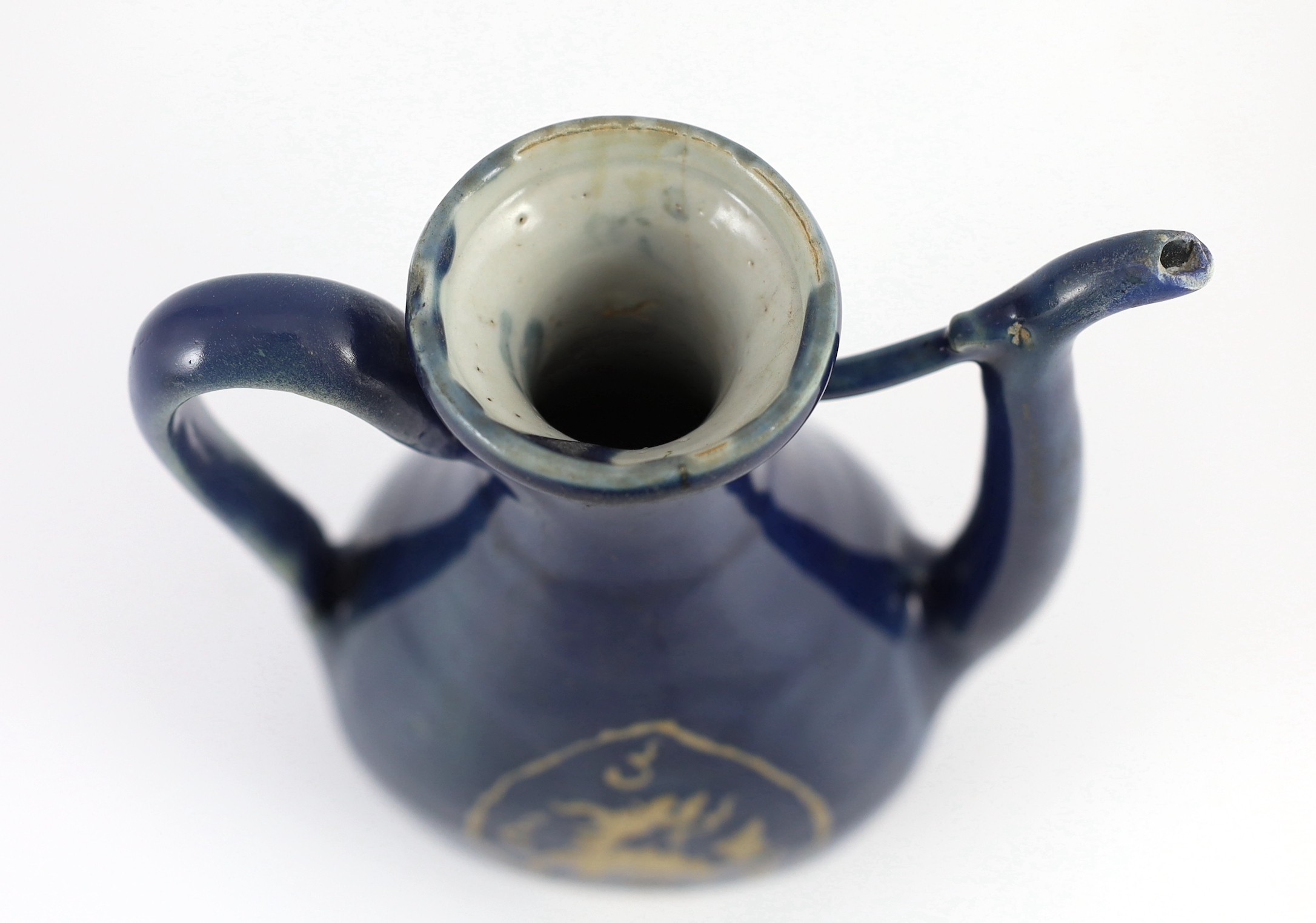 A Chinese late Ming blue glazed and slip decorated ‘qilin’ ewer, for the Islamic market, 19.5cm high, handle and tip of spout restored, wear